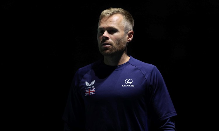 LTA Tennis Coach Mark Hilton wearing a Castore and Lexus branded t-shirt with a logo of the Great Britain flag while on court at the Davis Cup in Manchester