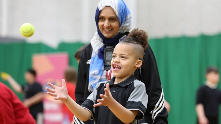 Young kid playing tennis at an LTA Tennis Foundation festival