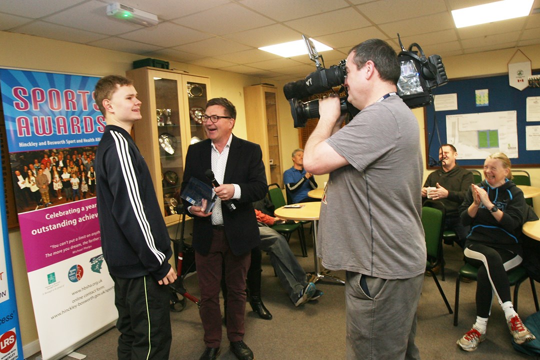 Matt being presented with his trophy infront of a camera