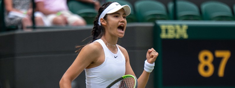 Emma Raducanu celebrating on a tennis court