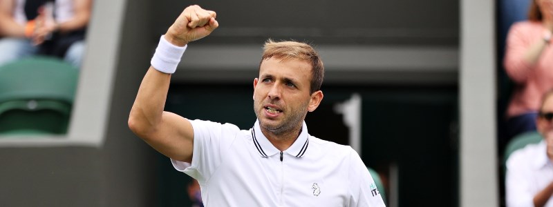 Dan Evans celebrating on a tennis court