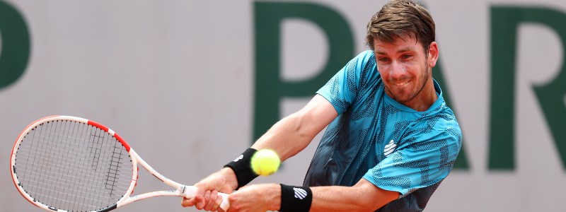 Cam Norrie playing a double forehand shot in a tennis match