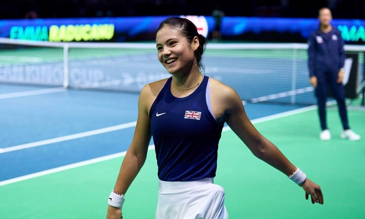 Emma Raducanu smiling on court after winning her match against Canada at the Billie Jean King Cup