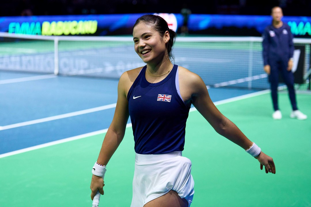 Emma Raducanu smiling on court after winning her match against Canada at the Billie Jean King Cup