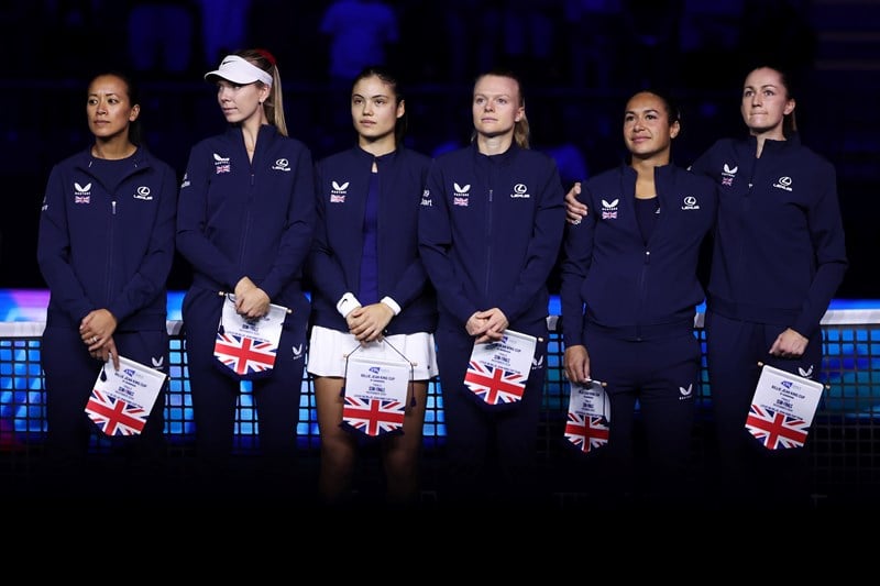 The Lexus Great Britain Billie Jean King Cup team (Anne Keothavong, Katie Boulter, Emma Raducau, Harriet Dart, Heather Watson and Olivia Nicholls) holding their flags and lined up next to each other ahead of their Billie Jean King Cup Finals semi-final match against Slovakia