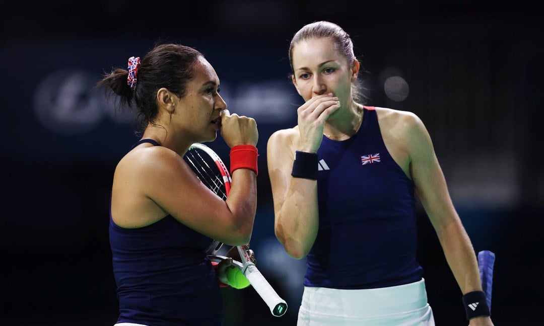 Heather Watson and Olivia Nicholls chatting on court during the Billie Jean King Cup doubles match against Slovakia