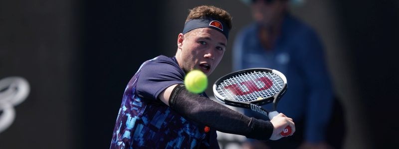 Alfie Hewett on court about to hit a backhand shot