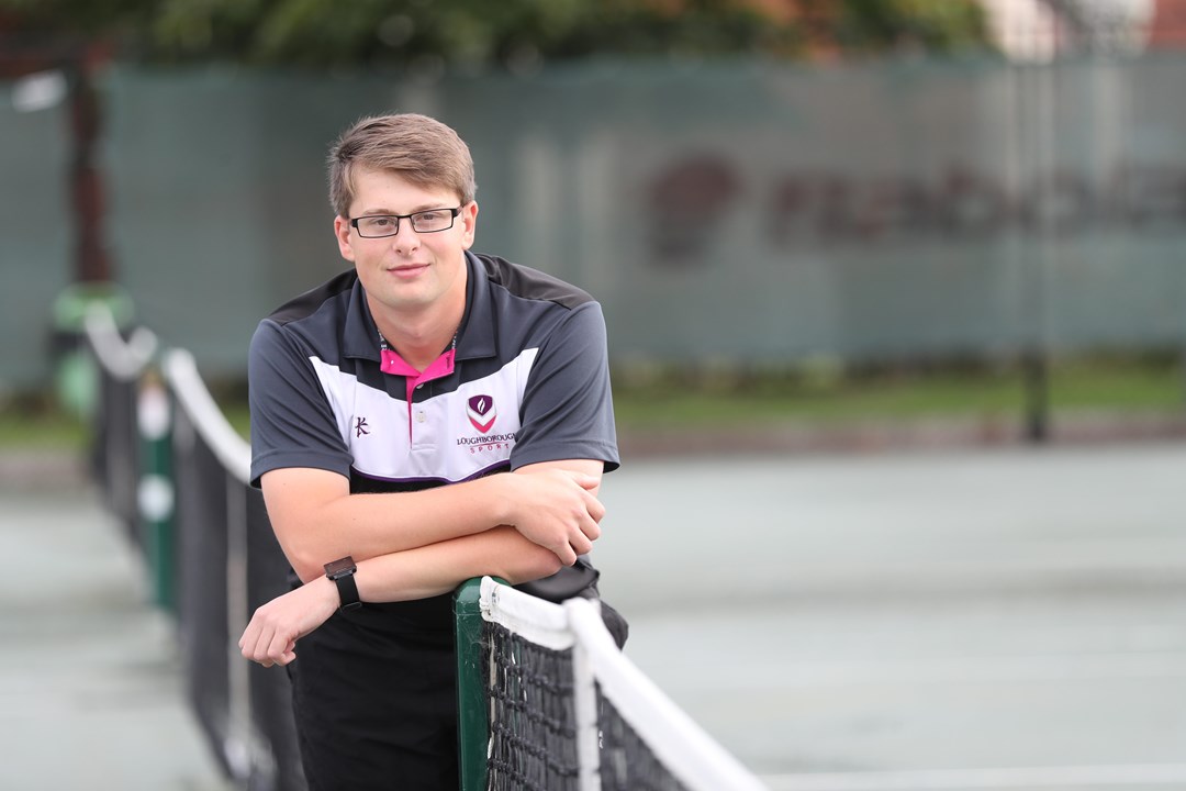 Conor Evans leaning on a net