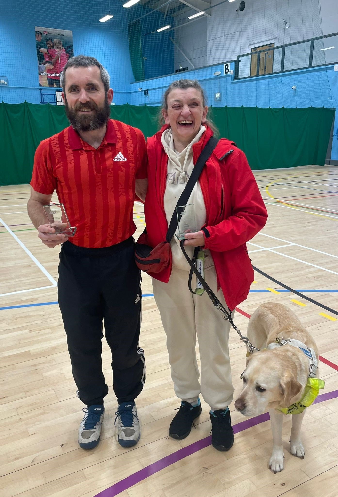 B1 doubles runners-up Roy Turnham (L) and Tracy Compton (R)  pictured with Guide Dog Sandy during the winner's ceremony.