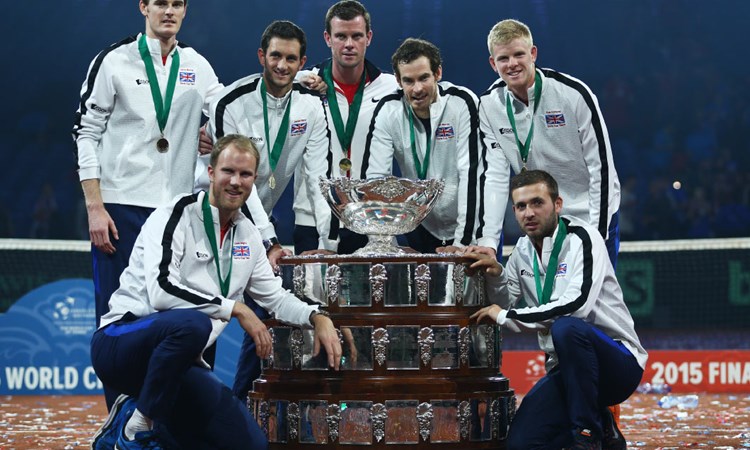 Great Britain players standing around a big trophy