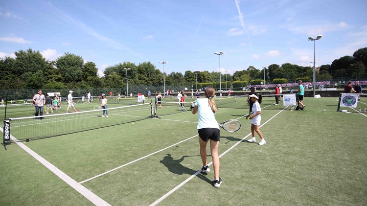 Tennis lessons taking place outside 