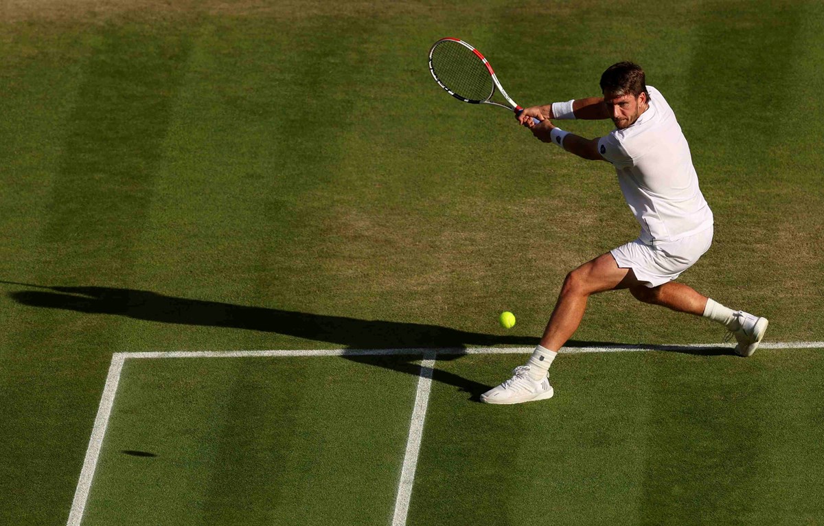 Cam Norrie hitting a backhand shot at Wimbledon