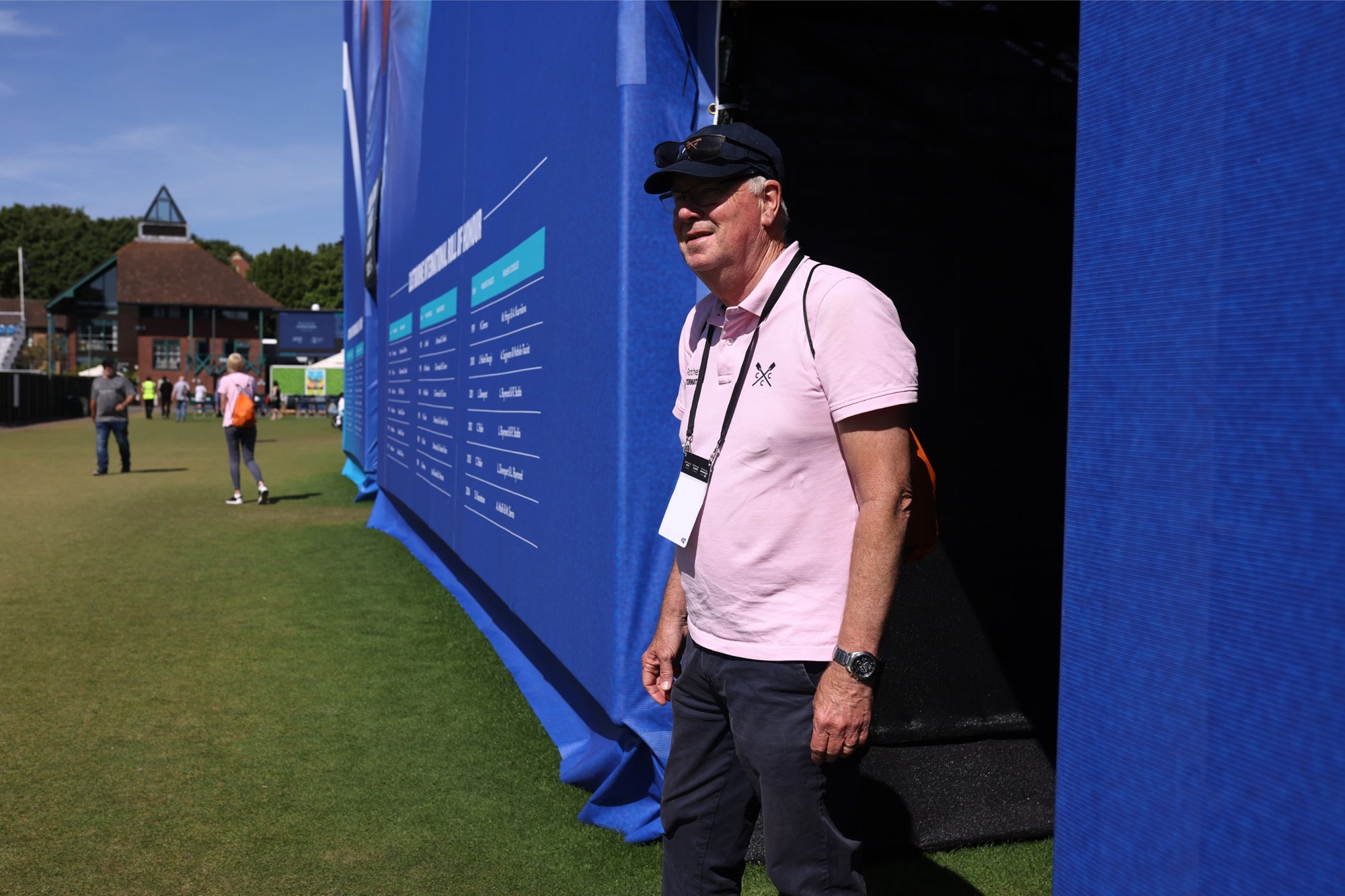 A volunteer walking off centre court after a match