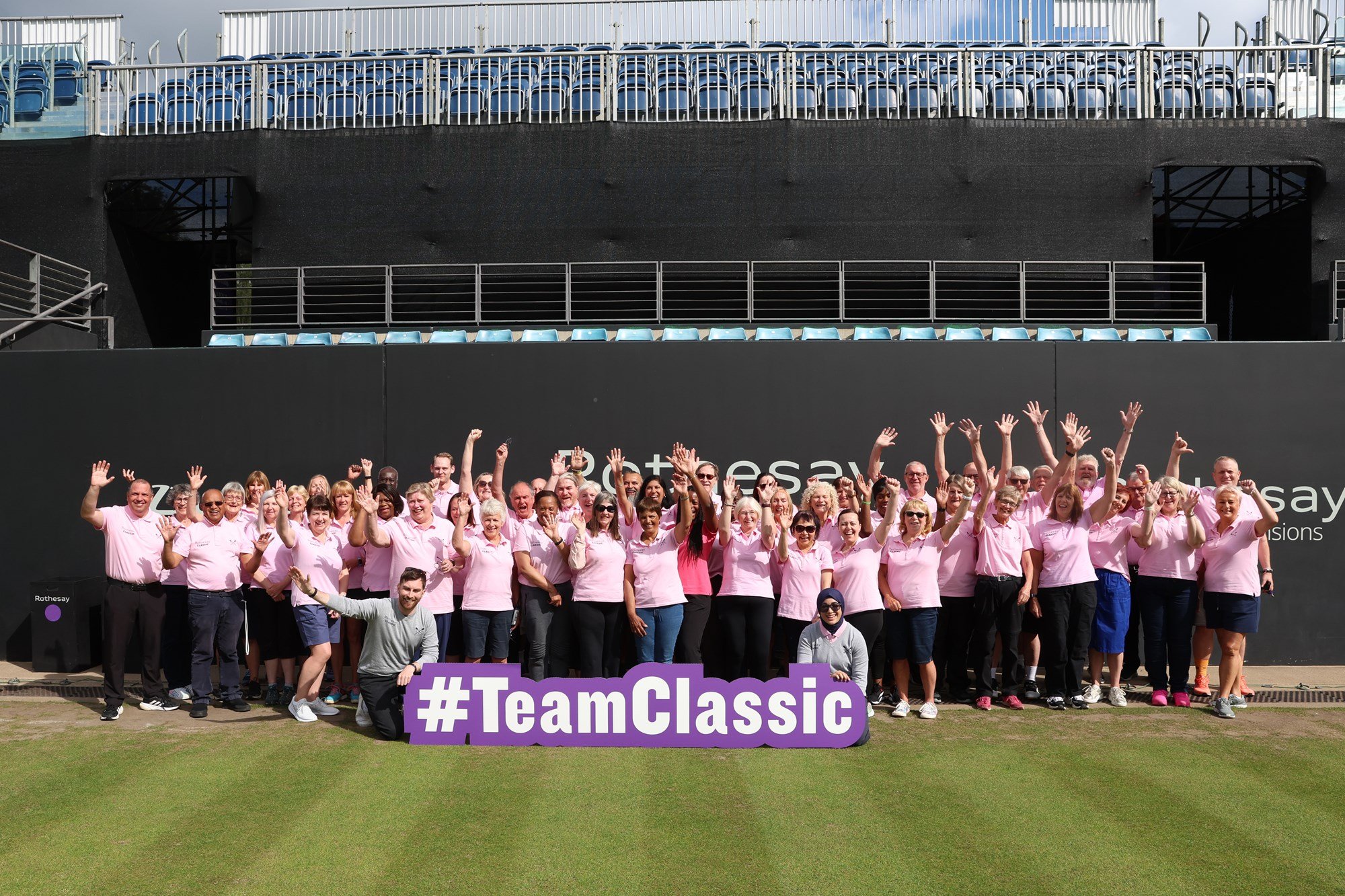 All the volunteers from Birmingham classic, crowded round a #TeamClassic sign waving and smiling at the camera