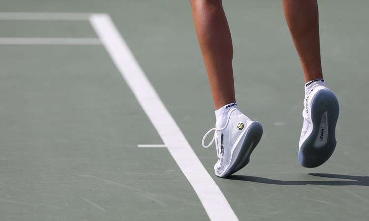 Close-up view of player's feet and legs on court