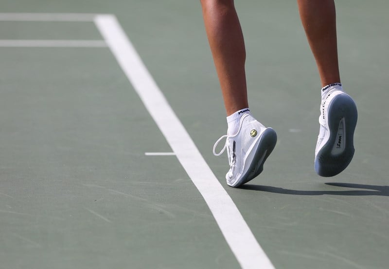 Close-up view of player's feet and legs on court