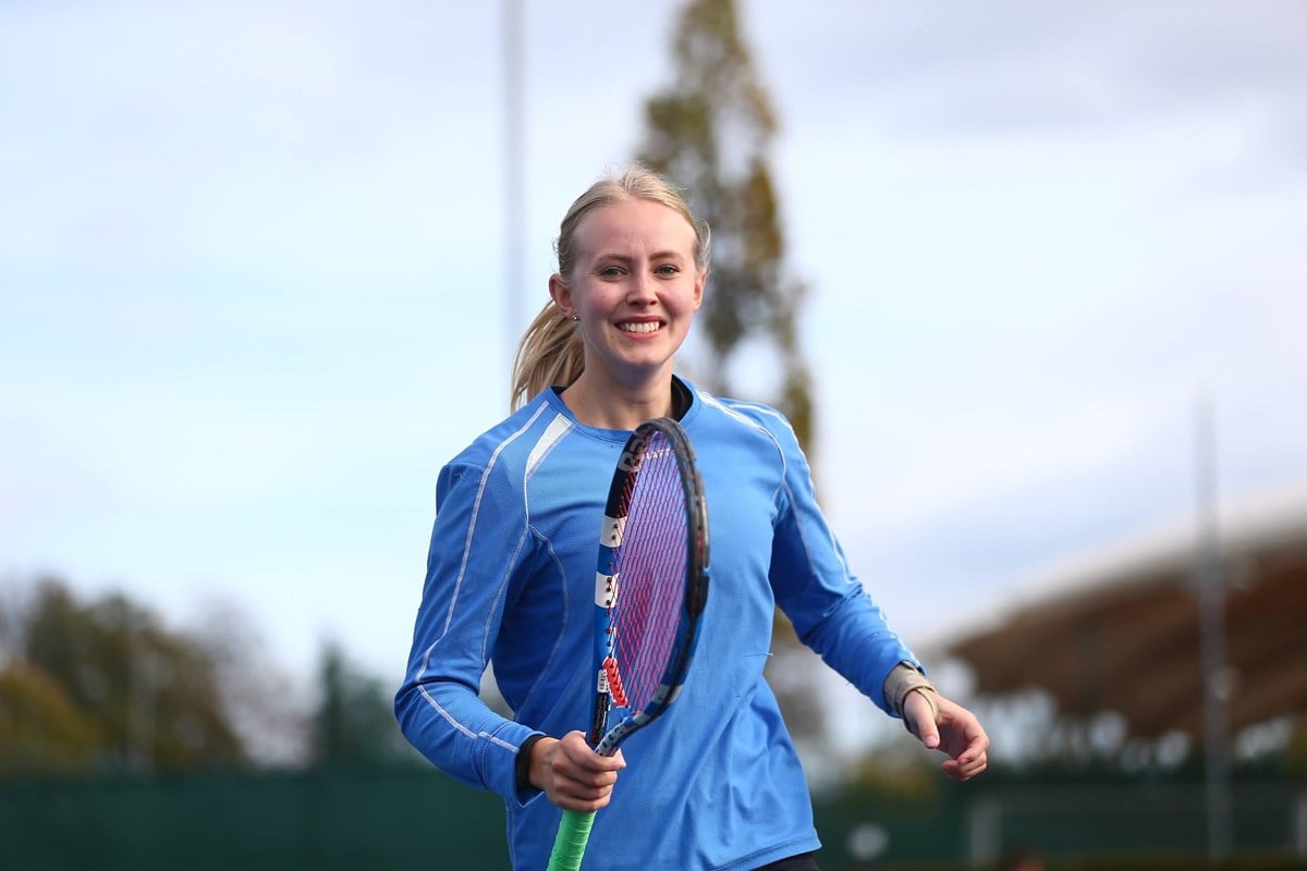 Young woman smiling and running towards camera.jpg