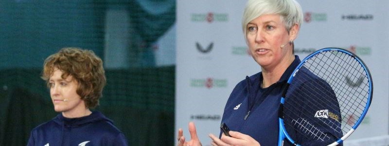 Jo Ward and Suzanne Williams standing next to each other with a tennis racket