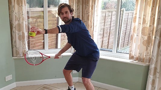 Matt Smith posing with tennis racket at home