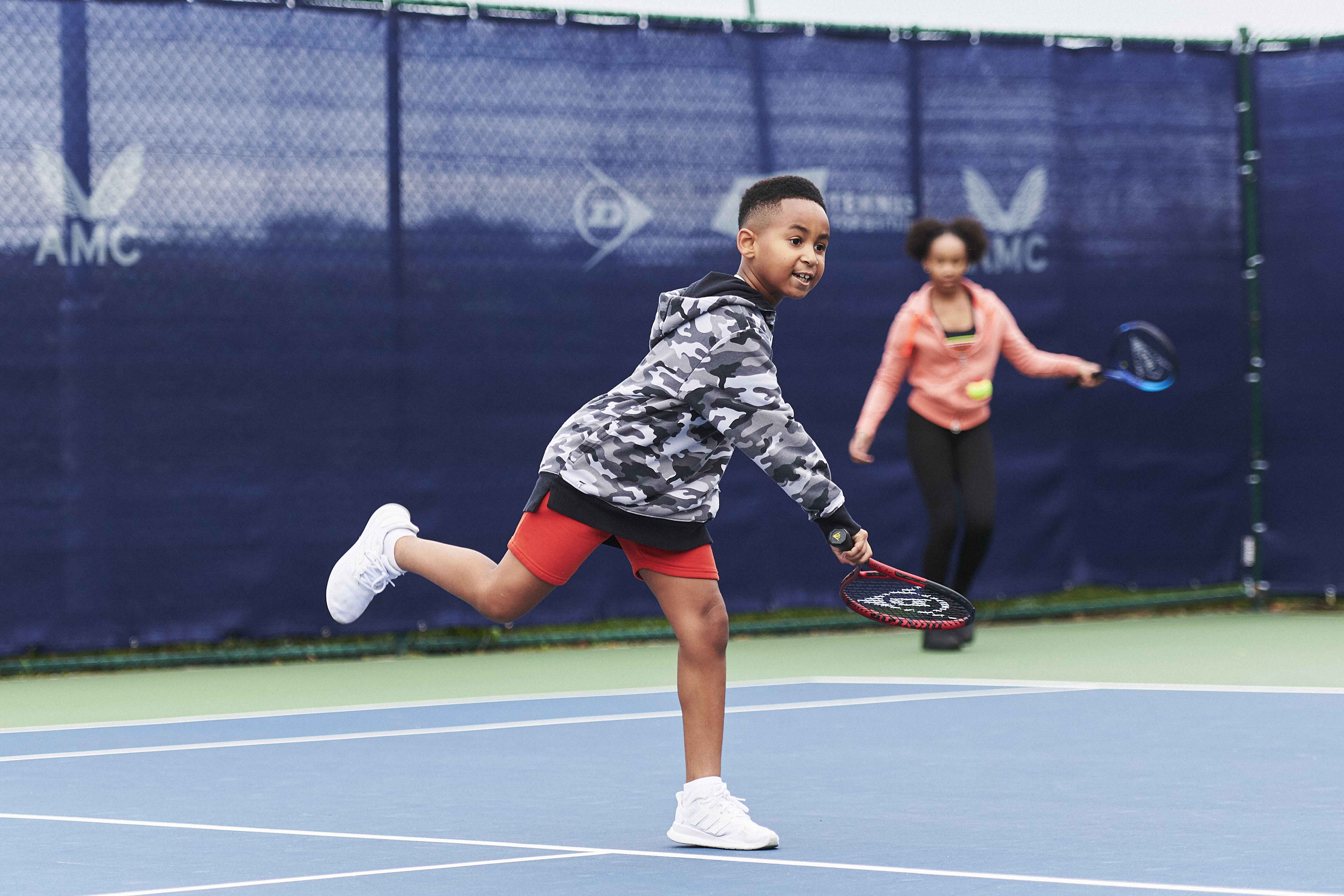 Kid hitting a serve.jpg